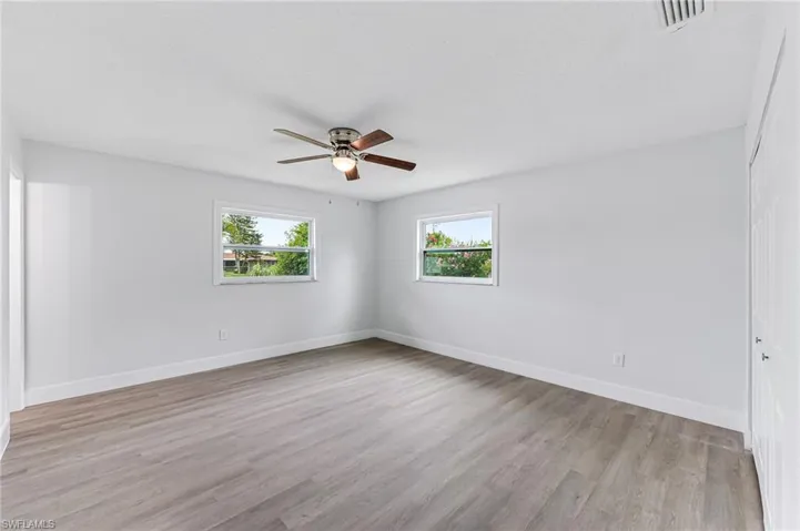 Unfurnished room with ceiling fan and light hardwood / wood-style floors