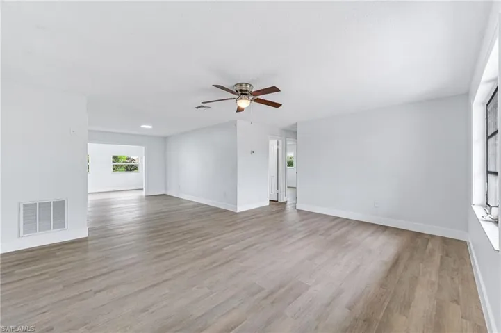 Unfurnished living room with light hardwood / wood-style floors and ceiling fan