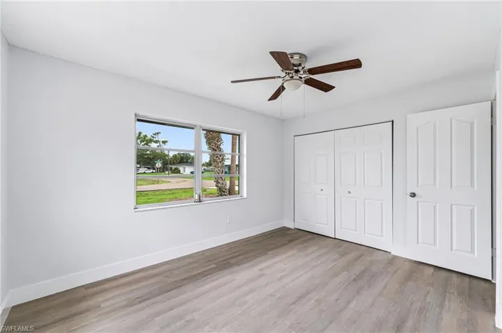 Unfurnished bedroom with a closet, wood-type flooring, and ceiling fan