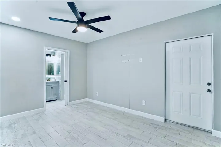 Unfurnished room with ceiling fan and light wood finished floors