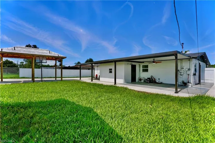 Back of house with a ceiling fan, stucco siding, and a patio area