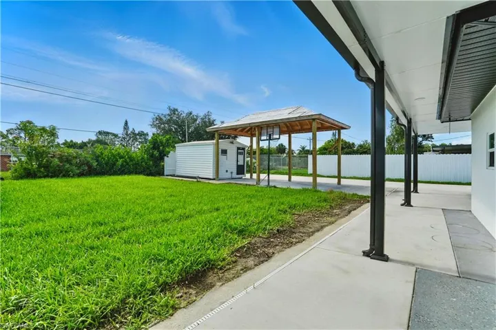View of yard featuring a gazebo, a patio, and a storage shed