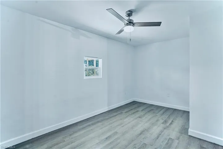 Empty room featuring wood finished floors and ceiling fan