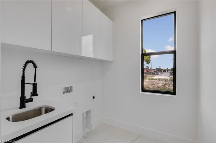 Laundry area with cabinet space, hookup for a washing machine, and hookup for an electric dryer