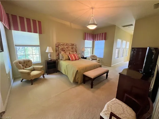 Bedroom featuring light carpet