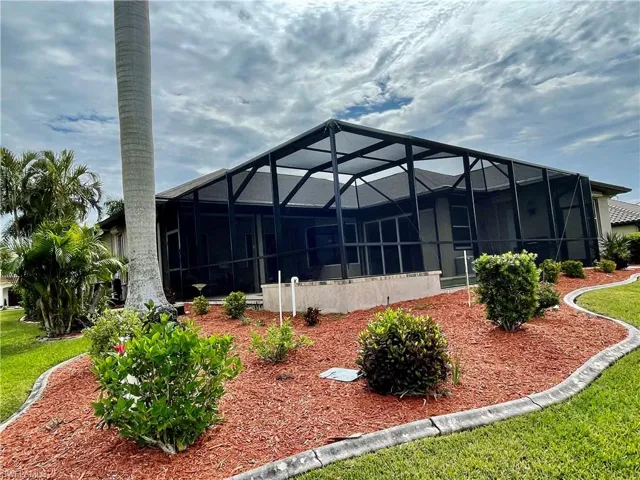 Rear view of house featuring glass enclosure