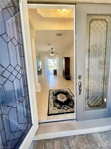 View of exterior entry featuring ceiling fan