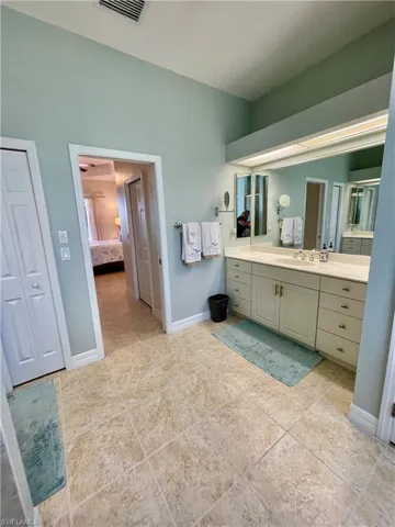 Bathroom with tile patterned floors and vanity