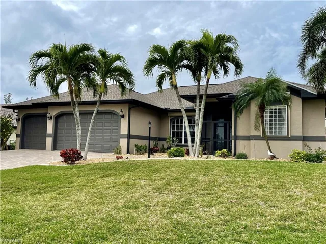 Single story home with a front yard and a garage