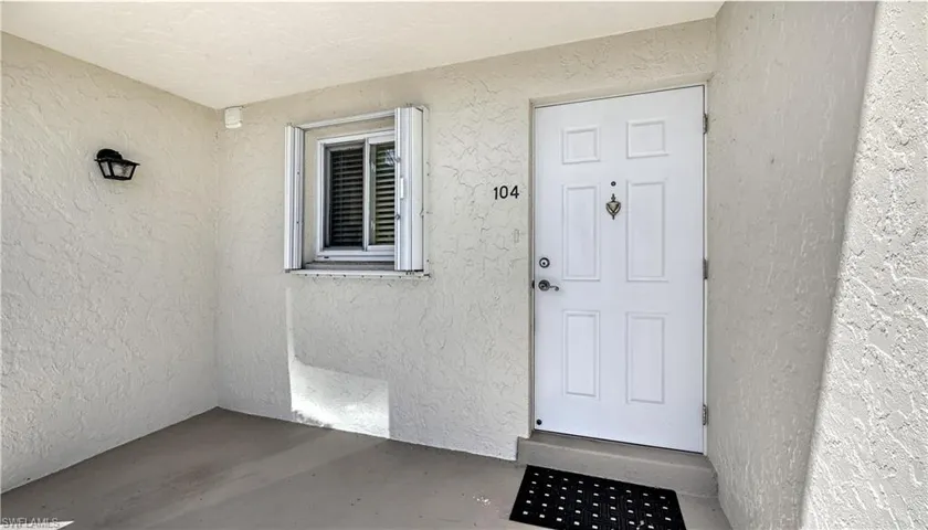 Entrance to property featuring stucco siding