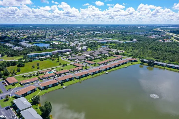 Aerial view of property and surrounding area featuring a large body of water