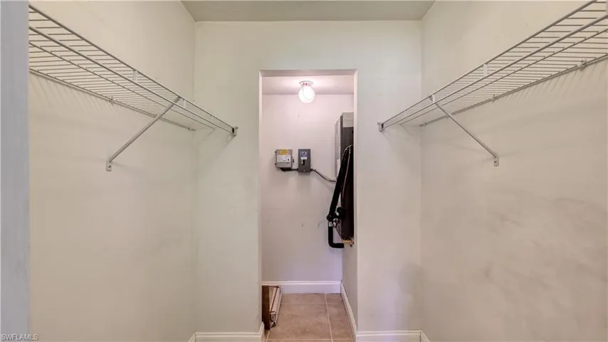 Walk in closet with light tile patterned floors