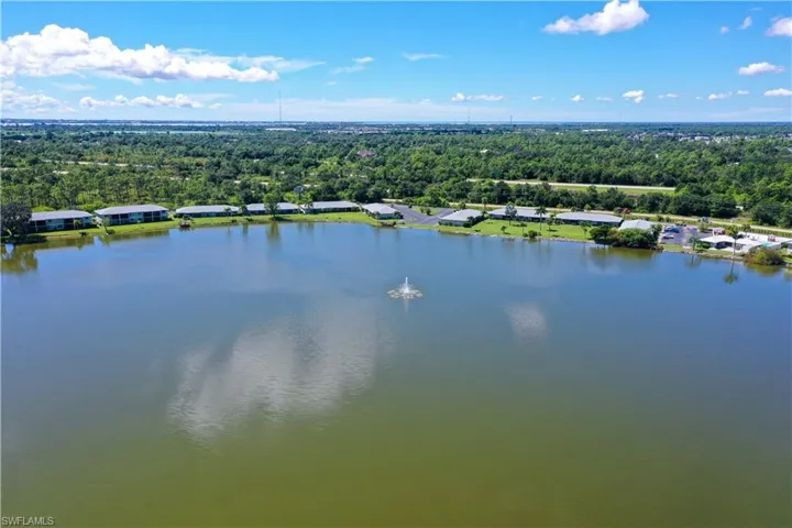 Aerial view of a nearby body of water and a heavily wooded area