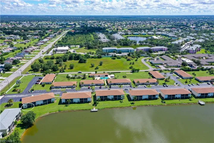 Aerial view of property's location with a large body of water