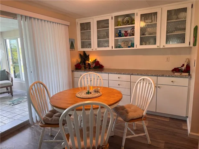 Dining room with large credenza and laminate flooring.