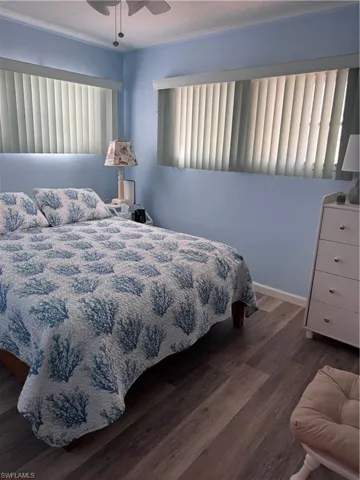 Bedroom with hardwood / wood-style flooring and ceiling fan