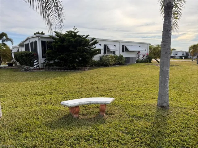 View of side yard featuring a Florida room