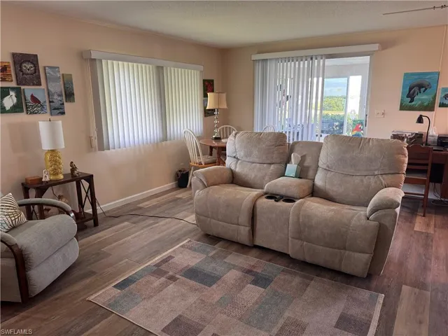Living room with laminate flooring and custom window treatments