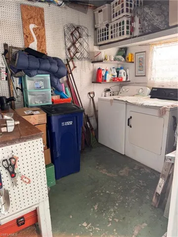 Shed under carport features washer/dryer, utility sink and work bench.