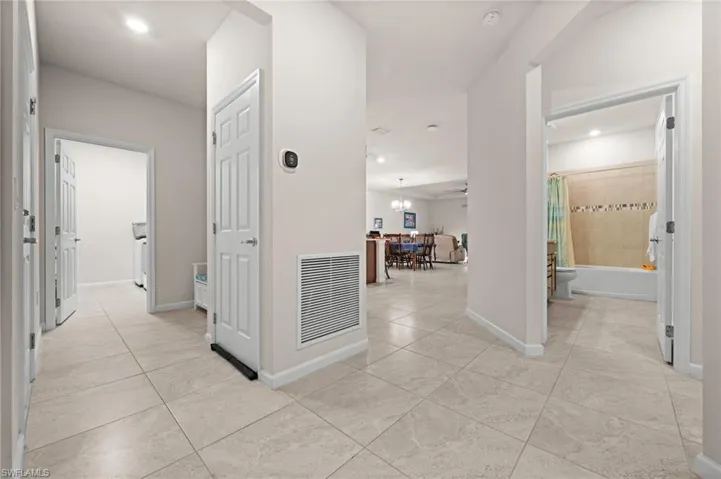 Foyer looking left into laundry room, bath 2 at right.