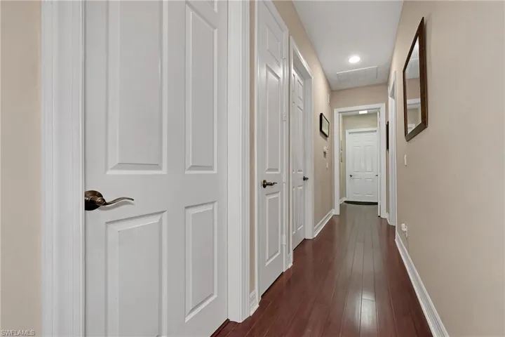 Hallway featuring dark wood finished floors and recessed lighting