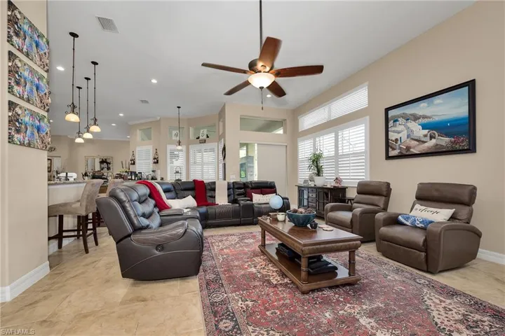 Living area featuring ceiling fan and recessed lighting