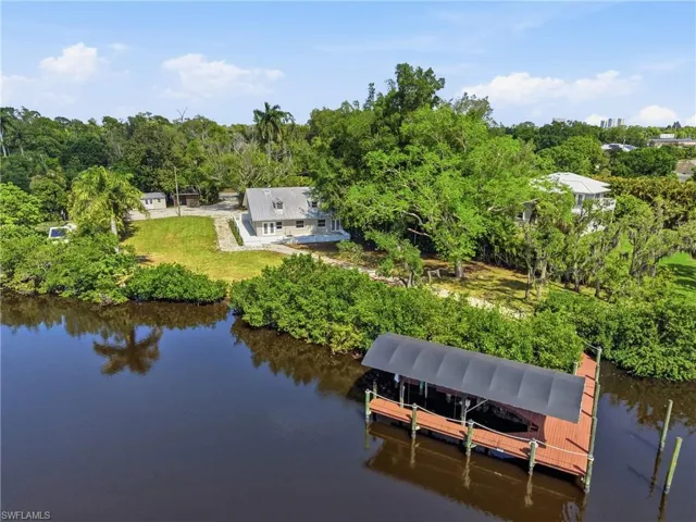 This property features a private boat dock with a covered slip, offering direct water access