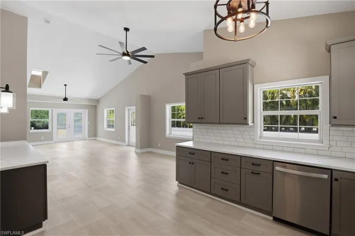 The property features an open-concept living area with vaulted ceilings, skylights, and light-colored flooring
