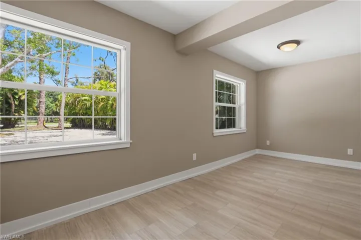 This room features light-colored flooring, windows providing natural light, and a ceiling light fixture