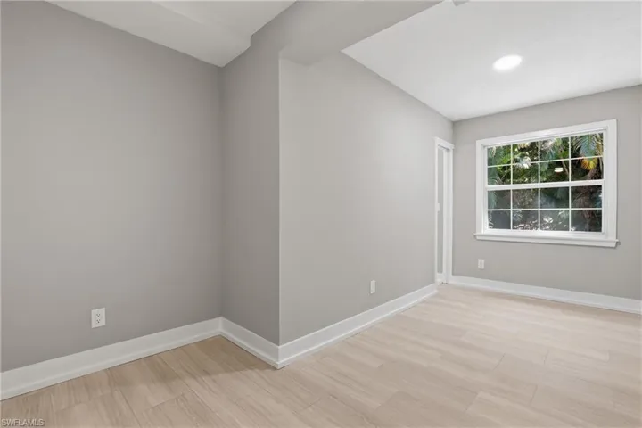 This room features light-colored flooring, neutral-toned walls, and a window with white trim