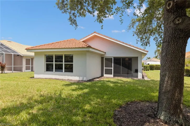 Rear view of property featuring a lawn