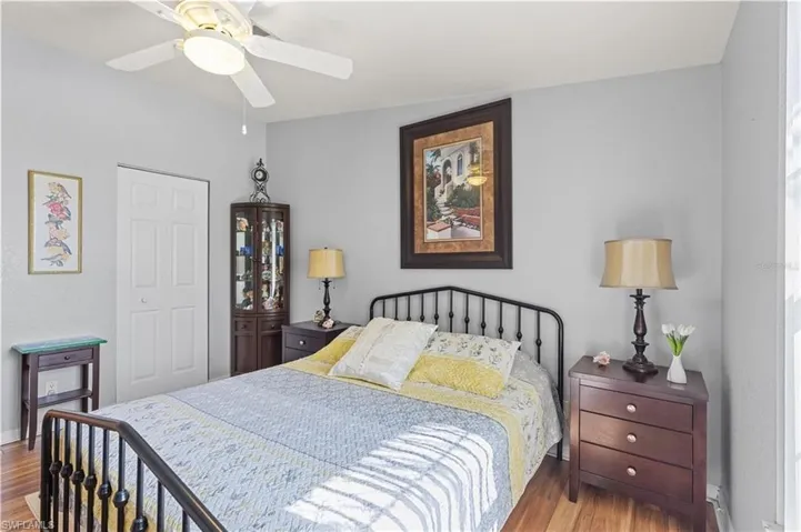 Bedroom with a closet, a ceiling fan, and wood finished floors
