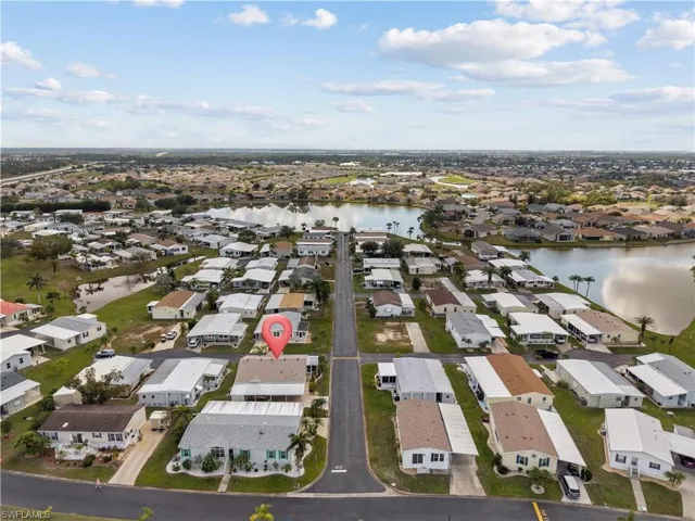 Aerial perspective of suburban area featuring a large body of water