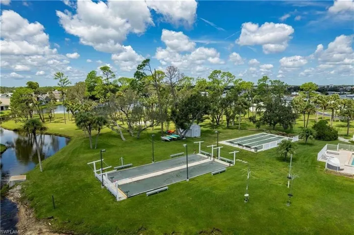 View of community featuring a bocce ball area and a water view