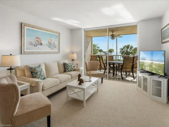 Living room with a wall of windows and a ceiling fan
