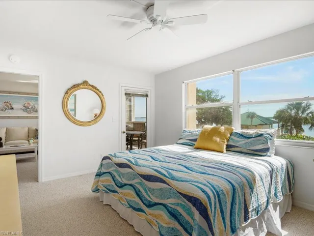 Carpeted bedroom with baseboards and a ceiling fan