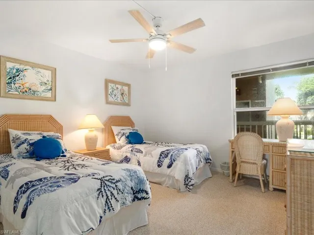 Carpeted bedroom with ceiling fan
