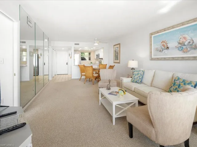 Living room with light carpet and a ceiling fan