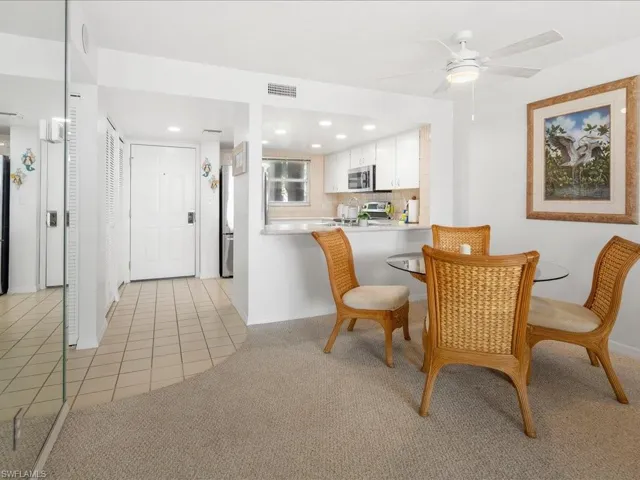 Dining room featuring light tile patterned flooring, a ceiling fan, light carpet, baseboards, and recessed lighting