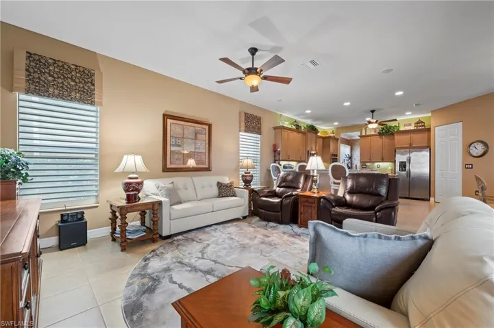Tiled living room featuring ceiling fan
