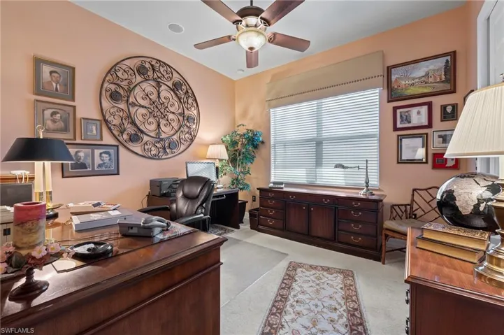 Office space featuring light carpet and ceiling fan