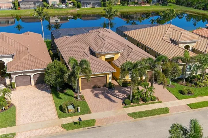 Birds eye view of property with a water view