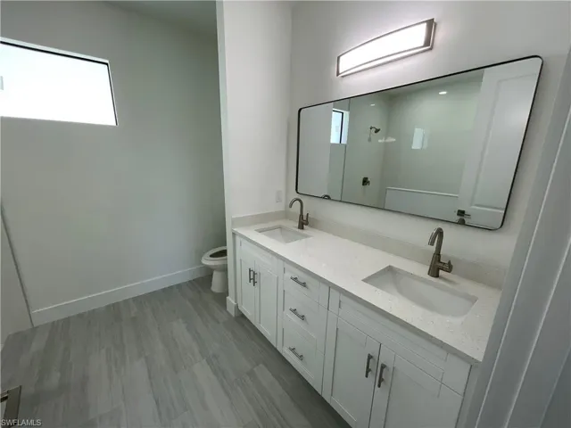 Full bath with double vanity and plenty of natural light