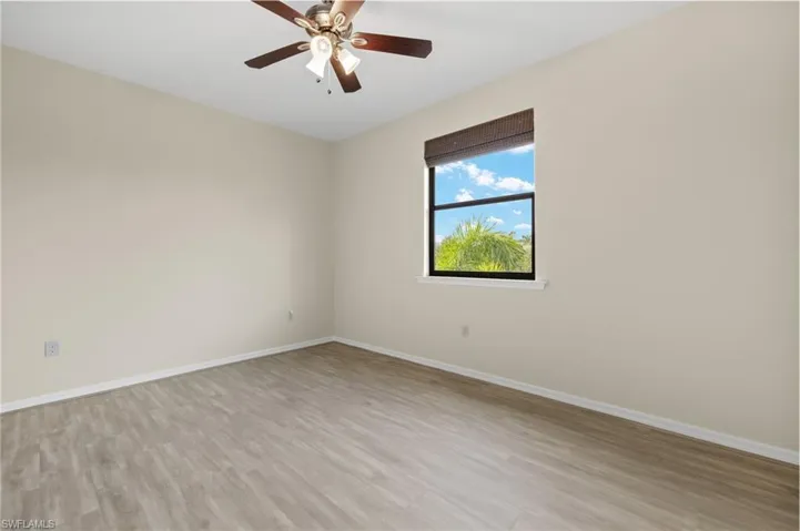 Spare room featuring light wood-type flooring and ceiling fan