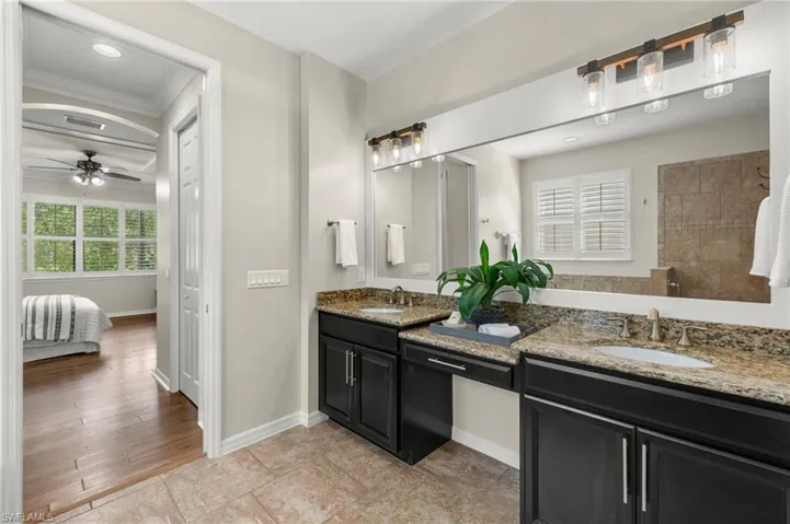 Bathroom featuring a healthy amount of sunlight, vanity, ceiling fan, and hardwood / wood-style flooring