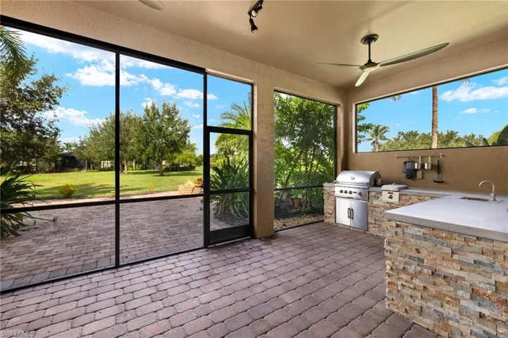 Sunroom featuring sink and ceiling fan