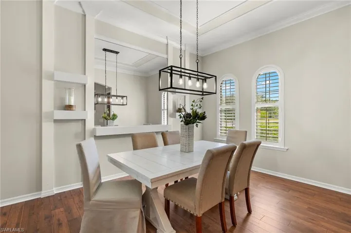 Dining area featuring dark hardwood / wood-style floors and crown molding