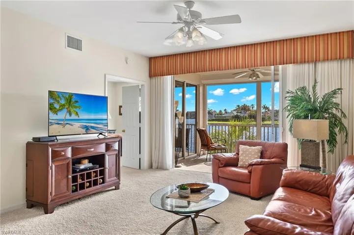 Living room featuring carpet flooring and ceiling fan
