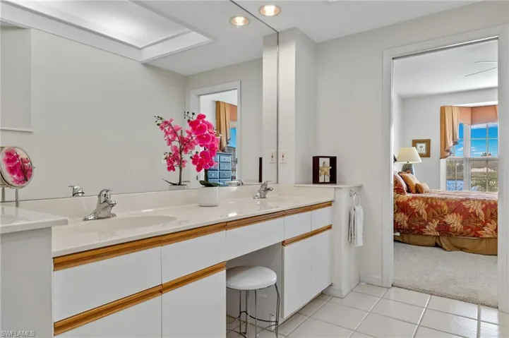Bathroom with dual vanity and tile flooring