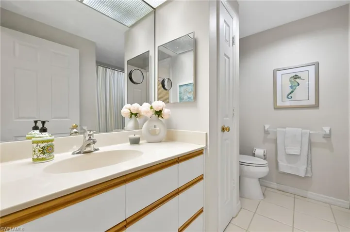 Bathroom featuring tile flooring, toilet, and oversized vanity
